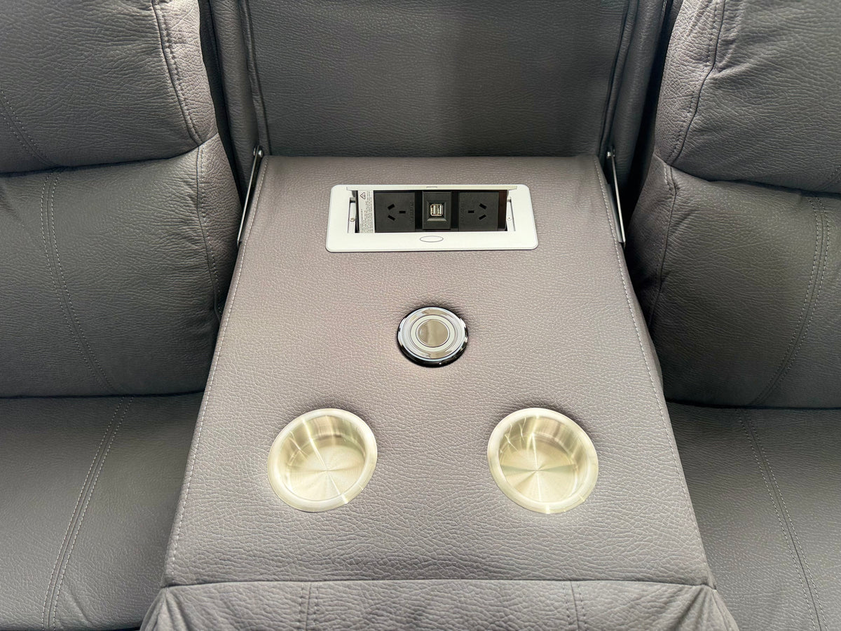 Drop-down console on the JASON 3 seater with two power points, USB ports, a wireless charging pad and two stainless steel cup holders