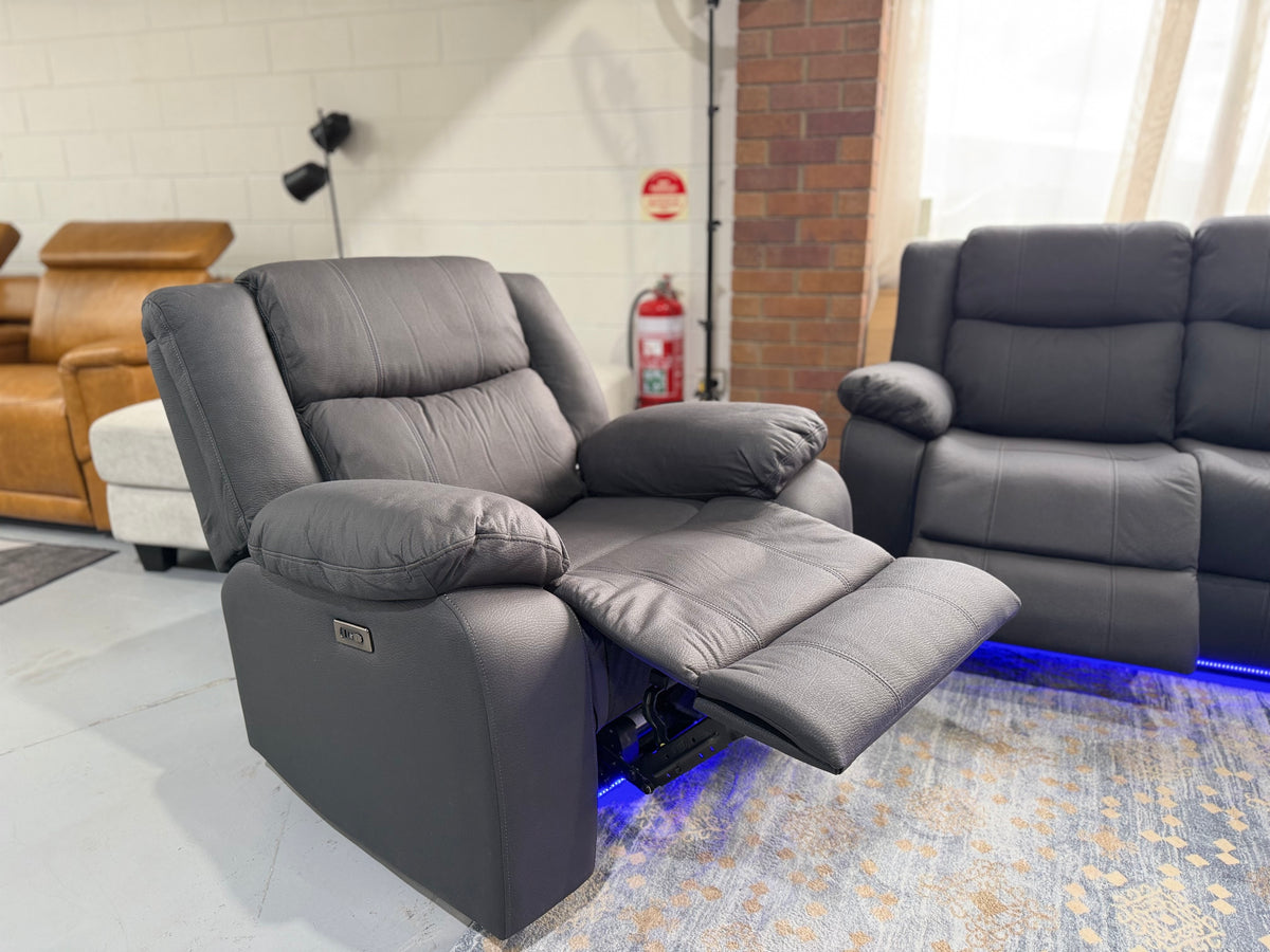 JASON single electric recliner armchair in black Rhino fabric with the footrest extended and the power button on the side