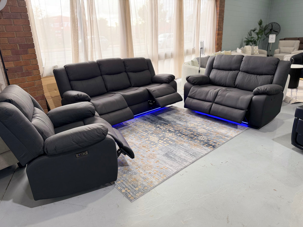 JASON 3+2+1 electric recliner suite in black Rhino fabric in the Hype Living showroom, footrests out and blue LED base lighting on